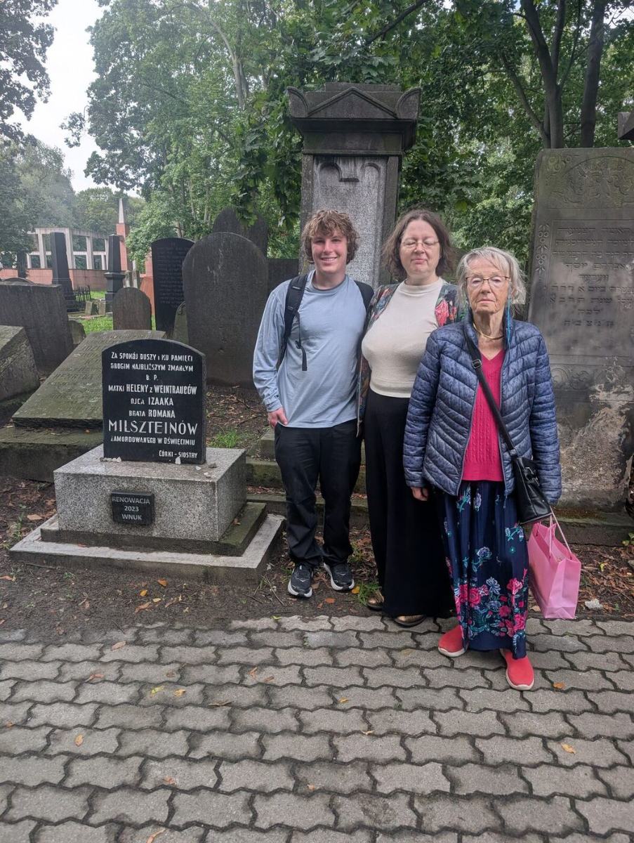 Jules with two women beside a restored family headstone