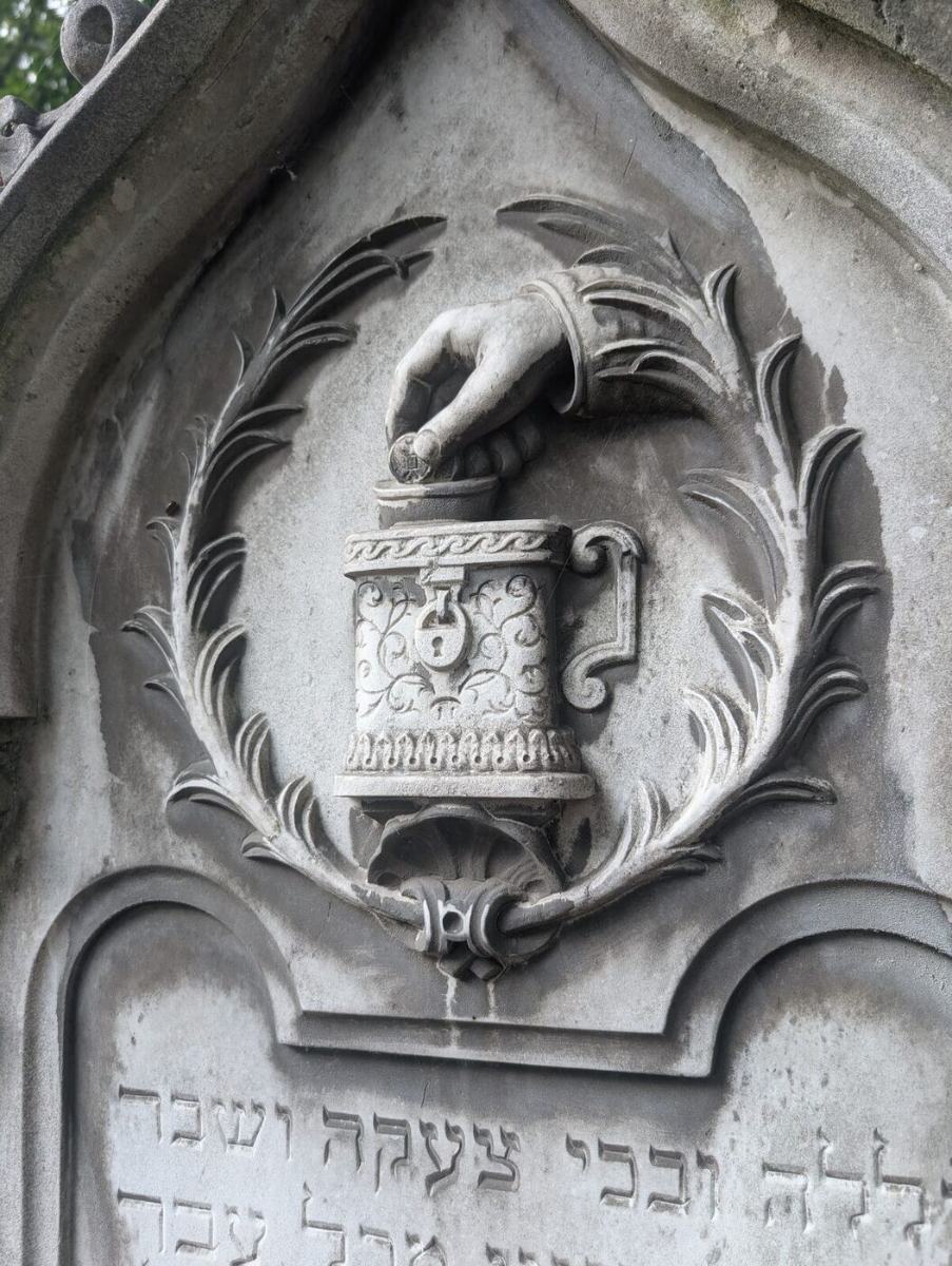 Carved hand and charity box relief, Warsaw
